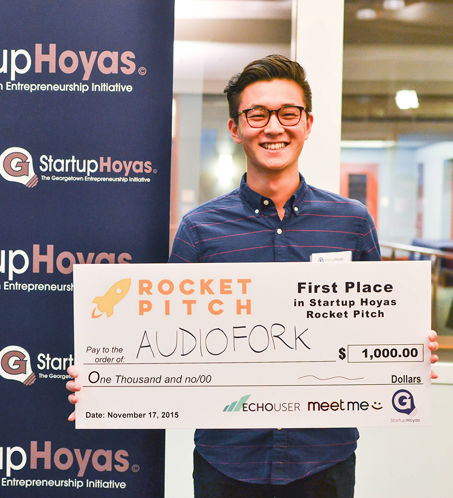 COURTESY JEFF REID 
First place StartupHoyas Rocket Pitch winner Eric Wu (SFS ’17) displays his $1,000 prize following the competition Tuesday evening. Wu pitched a mobile cooking application that provides hands-free guidance.
