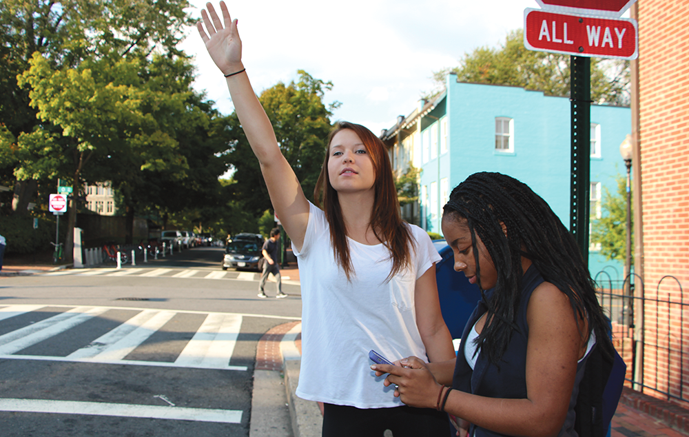 CLAIRE SOISSON/THEHOYA
McKenzie Schwarze (NHS ’17) and Alexis Campbell (COL ’17) hail a cab outside the front gates. Hailo, a new cab-hailing app, offers riders a 50 percent discount on weekday taxi rides. 