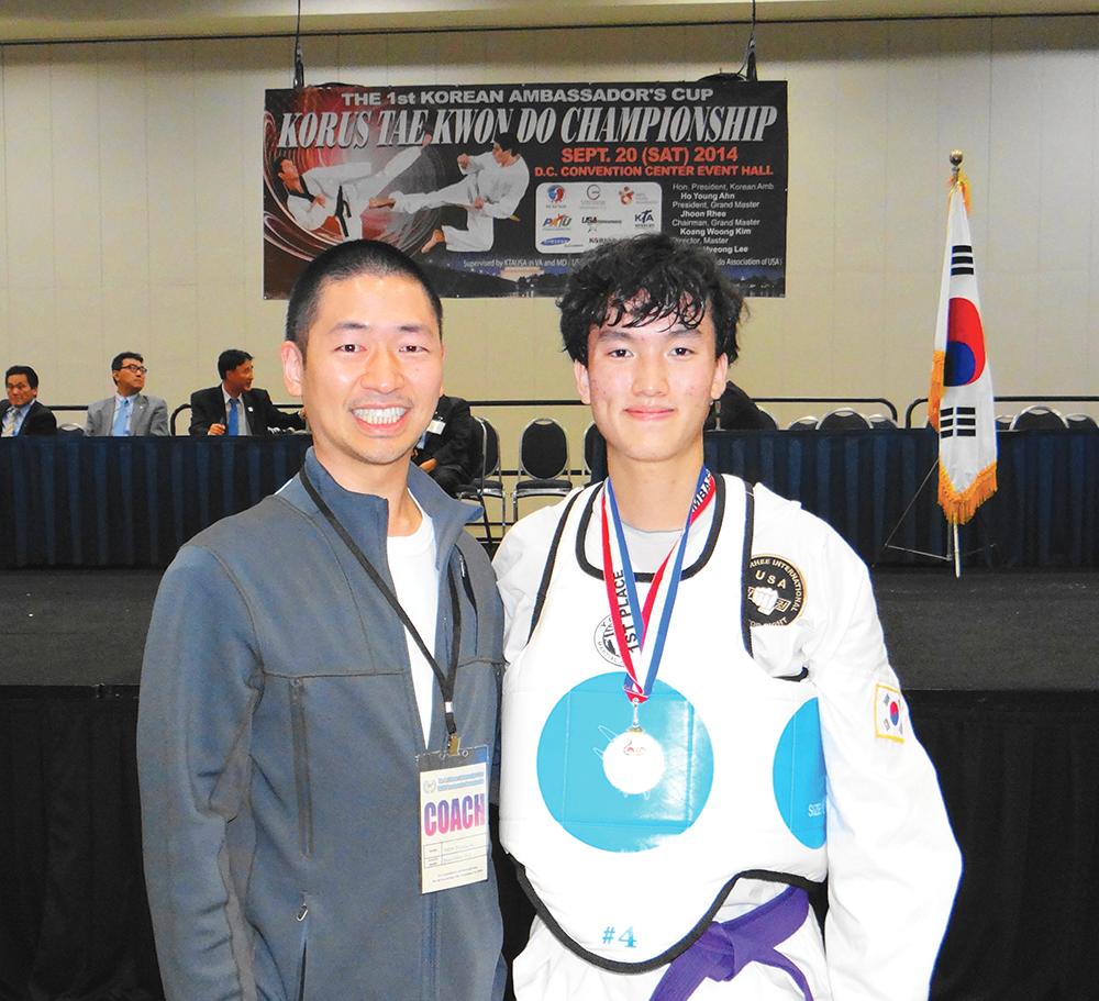 COURTESY OF GU TAE KNOW DO CLUB
Sophomore Daniel Kim dons the gold medal alonside his coach and GU Tae Kwon Do Club Head Instructor, Master Mickey Lee (COL ’05). 