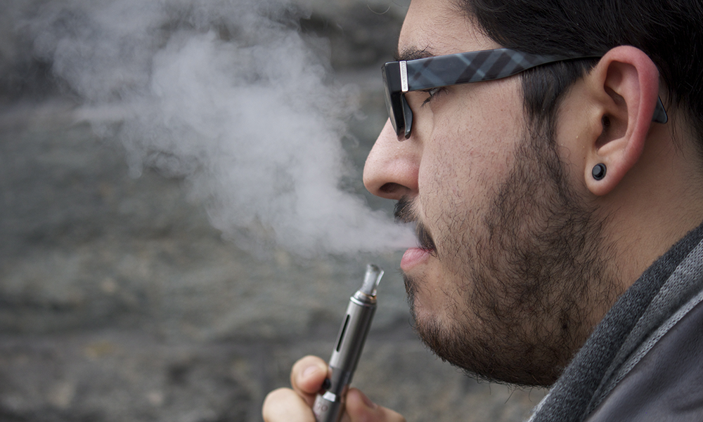FILE PHOTO: DANIEL SMITH/THE HOYA
Juan Luis Tirado (COL ’16) smokes an e-cigarette. In their report, Cobb and Abrams called for FDA approval of e-cigarettes. 