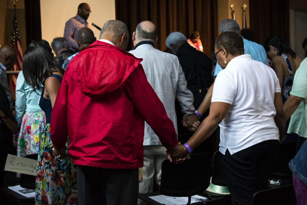 More than 500 descendants of the 272 men, women and children sold by the Maryland Jesuits to save Georgetown reunited over the weekend, pictured here joining in prayer. KARLA LEYJA/THE HOYA