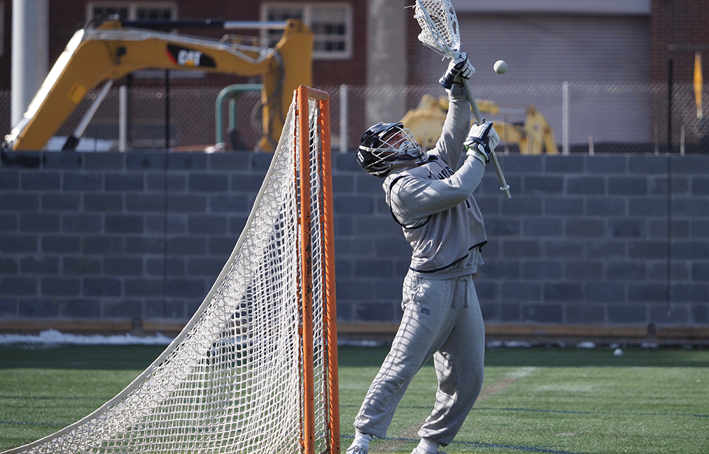KIRK ZIESER/THE HOYA | A Georgetown goalie goes up for a save during warm-ups. Sophomore goalie Owen McElroy tallied 16 saves in win over Sacred Heart.