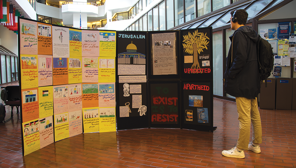 SHEEL PATEL/THE HOYA | Students gathered to create a mock wall of art for Israeli Apartheid Week on Monday. The artwork has been displayed in the Intercultural Center Galleria throughout the week.