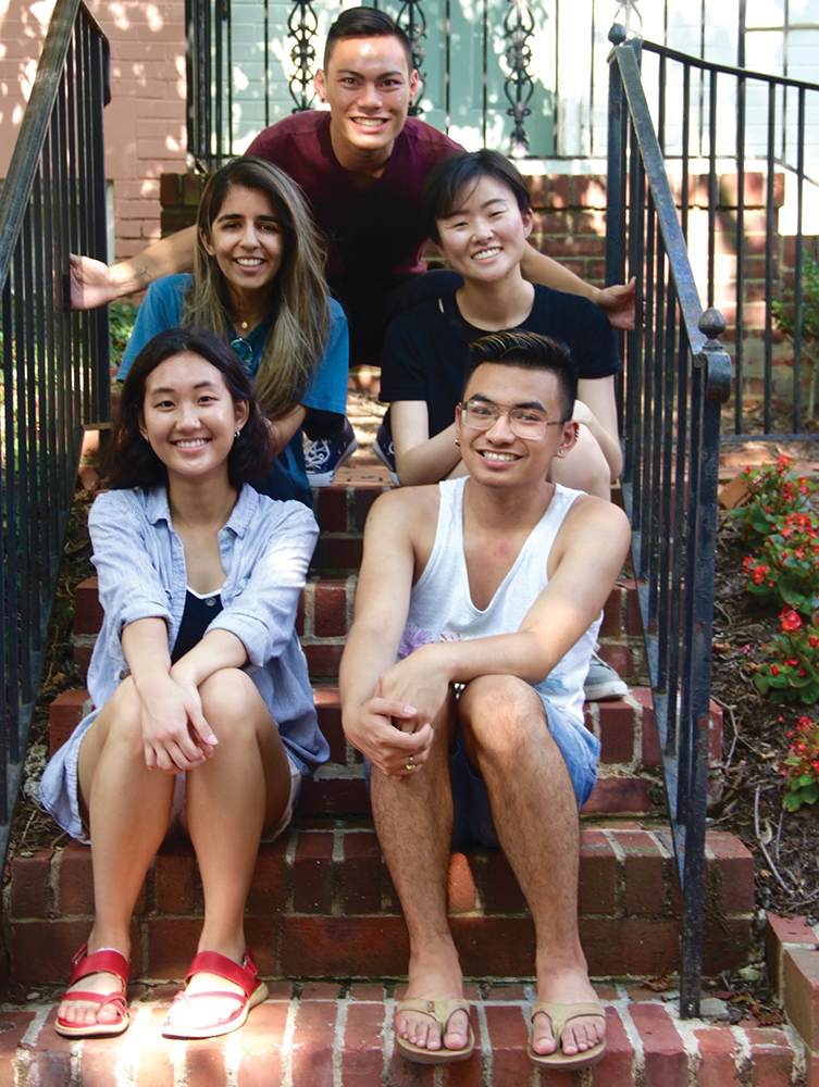 Current and former members of the Asian-Pacific Islander Leadership Forum sit in front of the Asian American Hub for Organizing, Movement and Empowerment (HOME) house. The Magis Row townhouse was opened this year, marking the first residential space for Asian American students on campus. 