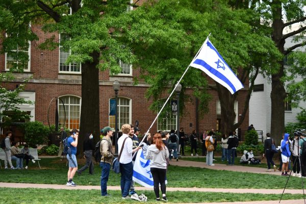 Maren Fagan/The Hoya|Pro-Israel counter-protesters displayed Israeli flags outside the encampment at George Washington University.