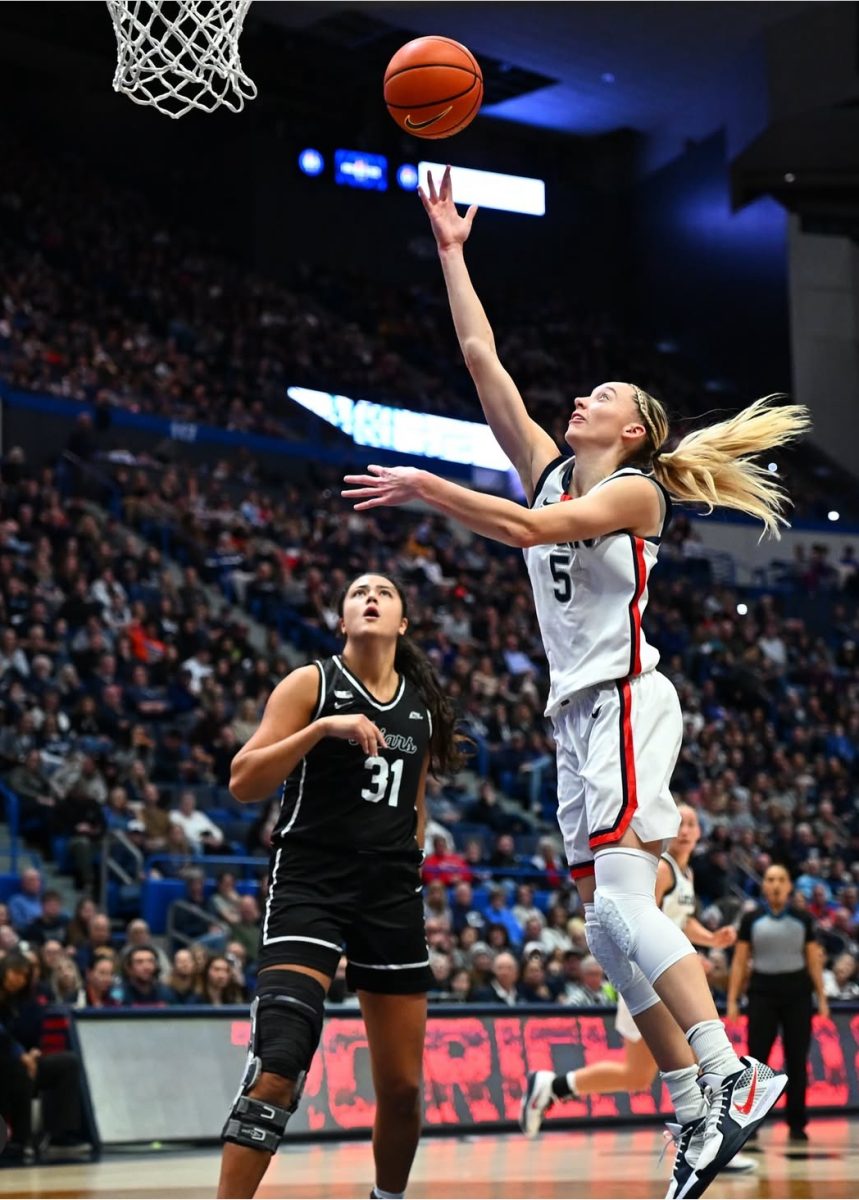 University of Connecticut (UConn) star Paige Bueckers shoots a layup during a game earlier this season. After a historic vote, NCAA women's basketball teams will now get paid for their participating in March Madness after years of increasing viewership. (@uconnwbb/Instagram)