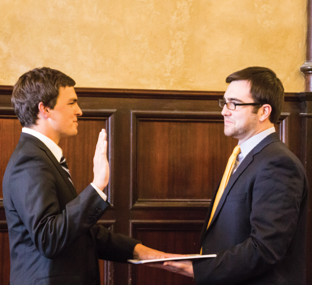 DANIEL SMITH/THE HOYA
Trevor Tezel (SFS ’15), left, takes the reins from outgoing GUSA 
President Nate Tisa (SFS ’14) in Healy Hall on Sunday.  