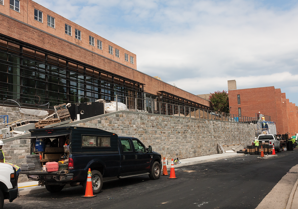MICHELLE XU/THE HOYA
Construction is continuing on the Healey Family Student Center in New South, which will open in September. The center’s auxiliary projects, The Corp’s Hilltoss salad shop and the university’s student pub, have been delayed to fully open later in the semester. 