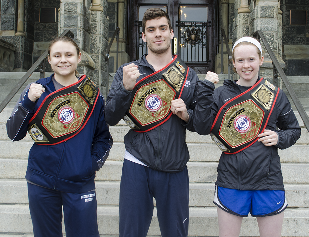 DAN GANNON/THE HOYA
Sophomore Corrina Di Pirro, left, junior Mike Minahan, center, and sophomore Sinead Schenk each earned an individual title belt at the USIBA National Championships to lead Georgetown’s club boxing team.