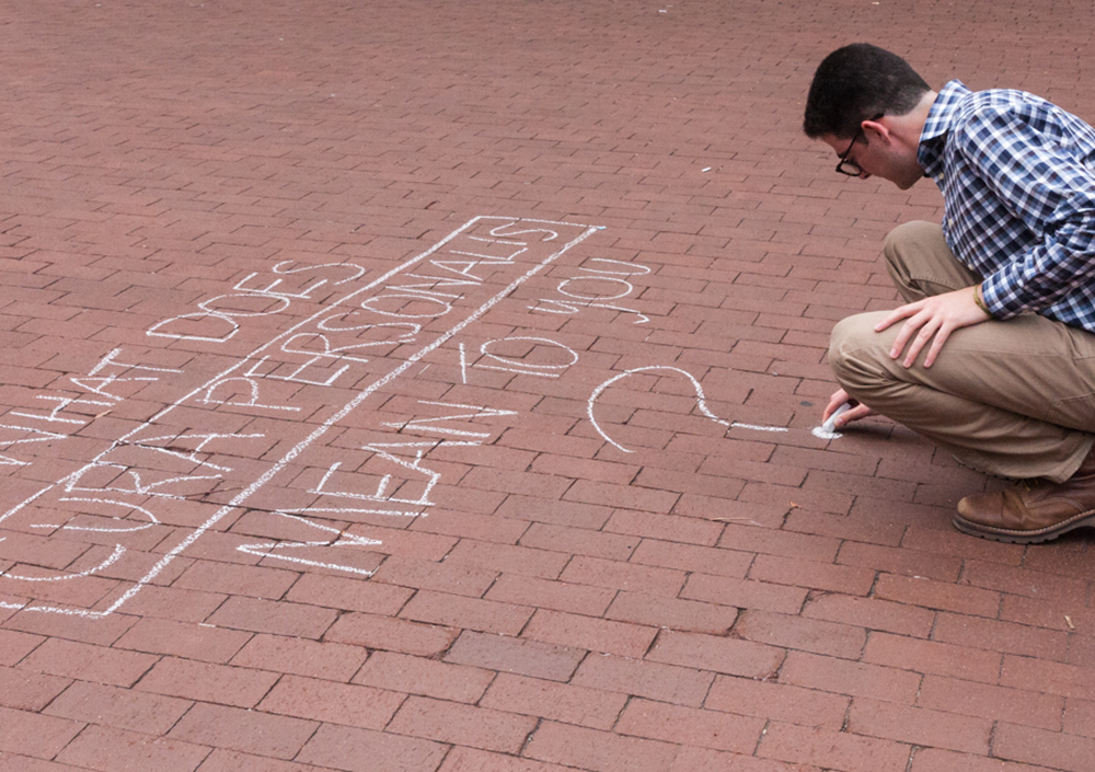FILE PHOTO: MICHELLE XU/THE HOYA
Ari Goldstein (SFS ’18) chalks Red Square at a summer event geared toward garnering university administrators’ attention on sexual assault.