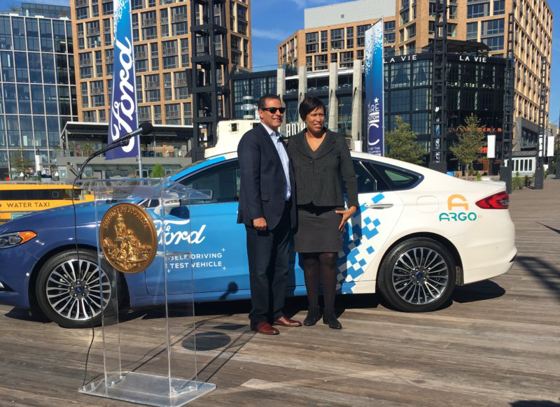 BRITISH PARKING Ford Autonomous Vehicles President and CEO Sherif Marakby (left) and Mayor Muriel Bowser (D) (right) announced a partnership to test autonomous vehicles in Washington, D.C., early next year. Ford will also run a training program for workers displaced by driverless cars.