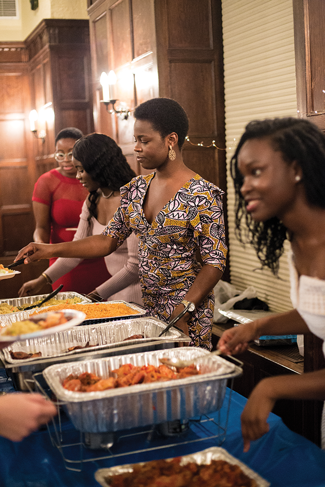Kristen Okoro, Danielle Maduka, Eliza Phillips, and Ojuolape Junaid serve food to Ubuntu diners STEPHANIE YUAN/THE HOYA