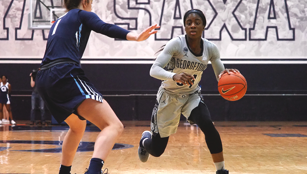 KIRK ZIESER/THE HOYA | Graduate guard Dorothy Adomako drives to the basket in a home game for the Hoyas.