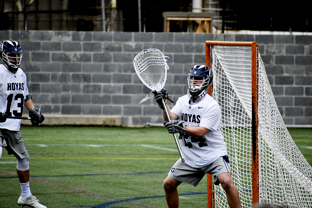 MARGARET FOUBERG/THE HOYA | Sophomore goaltender Owen McElroy positions himself to stop a Villanova shot, as he stifled the opposing offense to eight goals in the final three quarters.