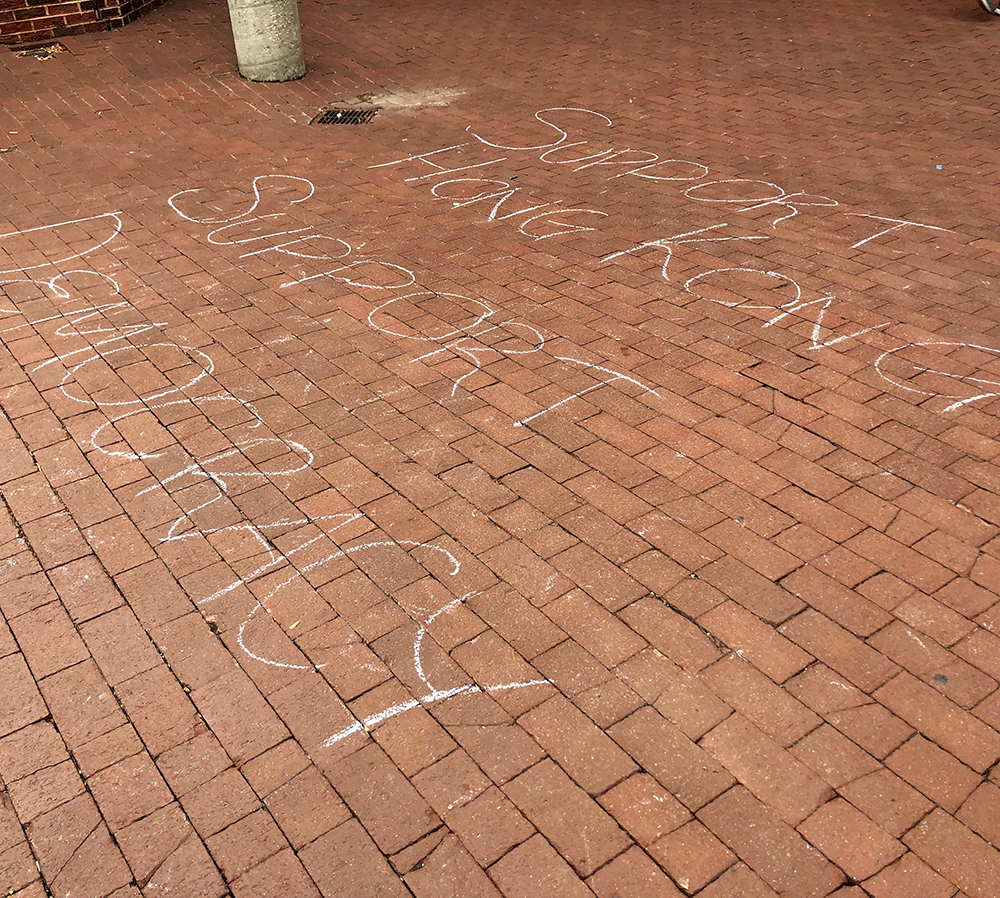 SUBUL MALIK / THE HOYA | Activists chalked opposing messages in Red Square regarding ongoing demonstrations in Hong Kong about the citys relationship to China.