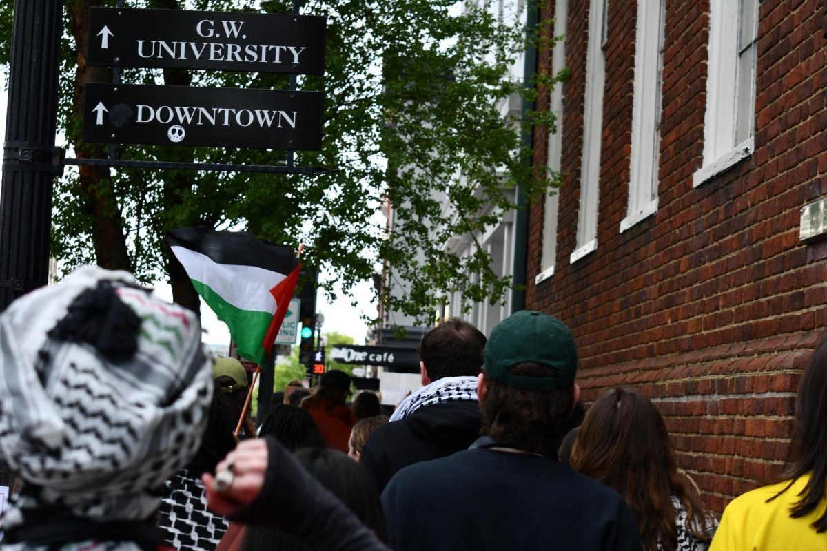 Maren Fagan/The Hoya | Waving Palestinian flags, Georgetown University students, faculty and staff passed through the Georgetown neighborhood.