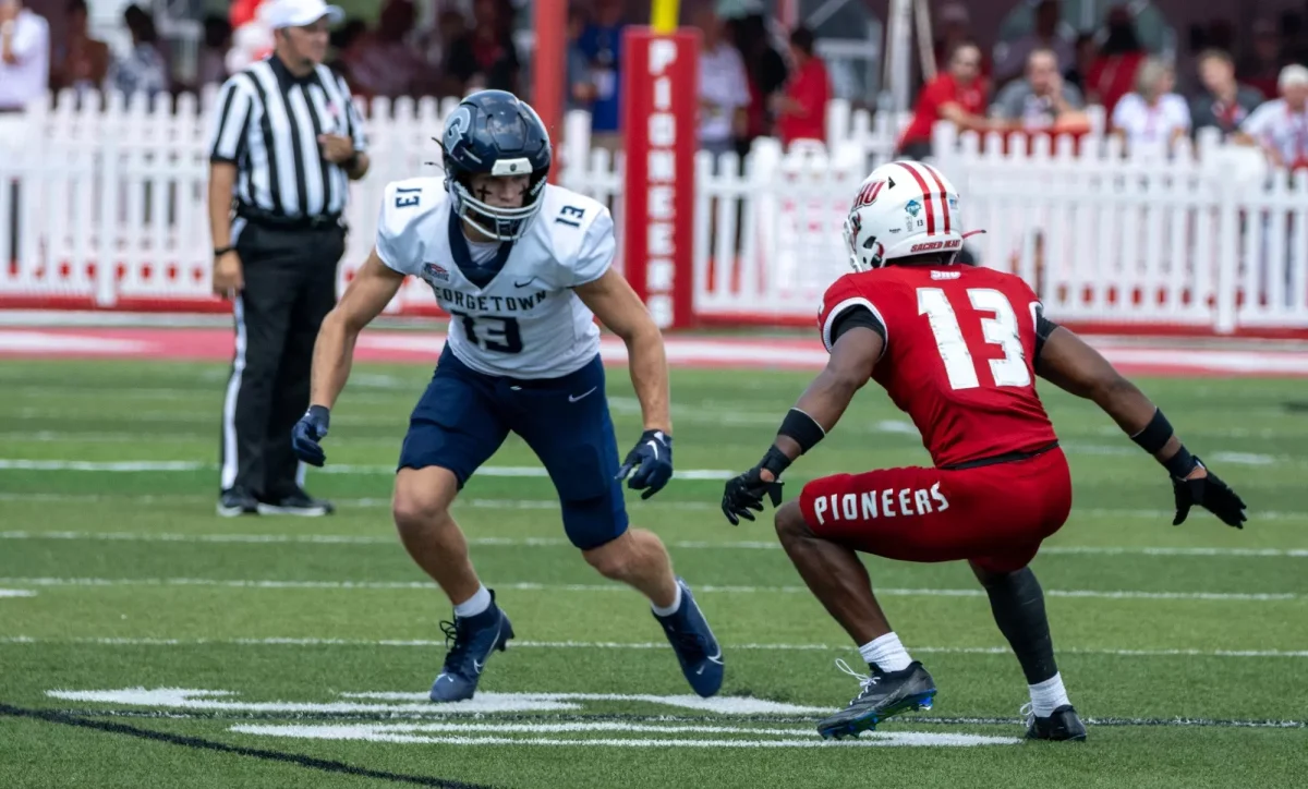 Hoyas junior wide receiver Jimmy Kibble maneuvers around Sacred Heart defensive back Kenny Selby for an offensive gain. The Hoyas fell 40-14 to the Pioneers. 
