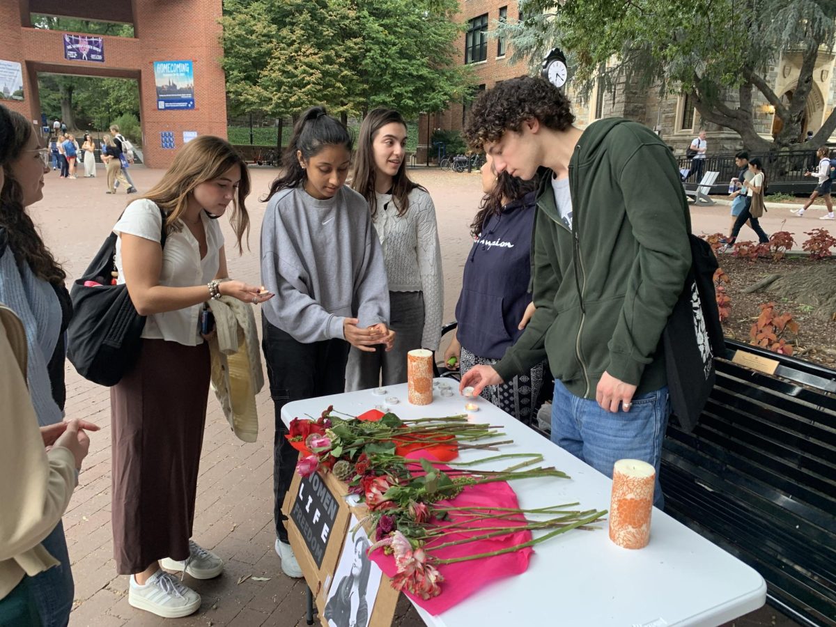 Kate Hwang/The Hoya | Georgetown University community members gathered at a commemorative vigil to mark the second anniversary of Mahsa Amini’s death on Sept. 16.