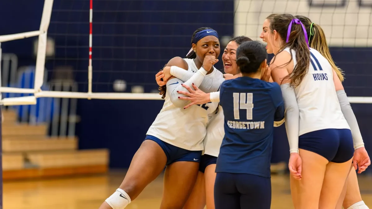 The Georgetown Volleyball team celebrate after winning a set in their five-set victory versus DePaul.