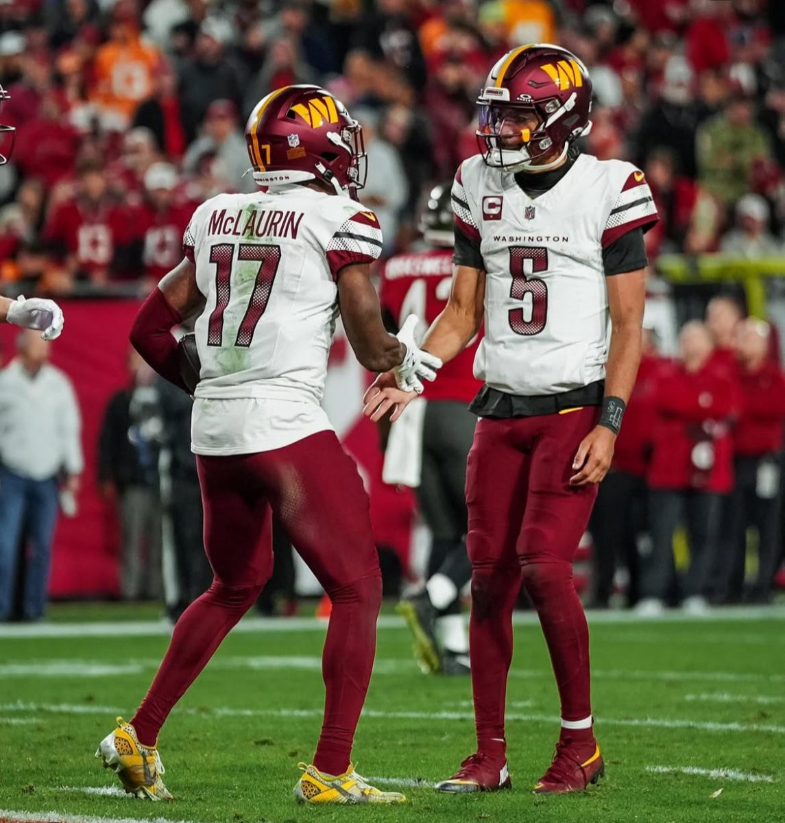 Washington Commanders quarterback Jayden Daniels celebrates a touchdown with wide receiver Terry McLaurin during the Commanders' 23-20 playoff win over the Buccaneers Jan. 12.