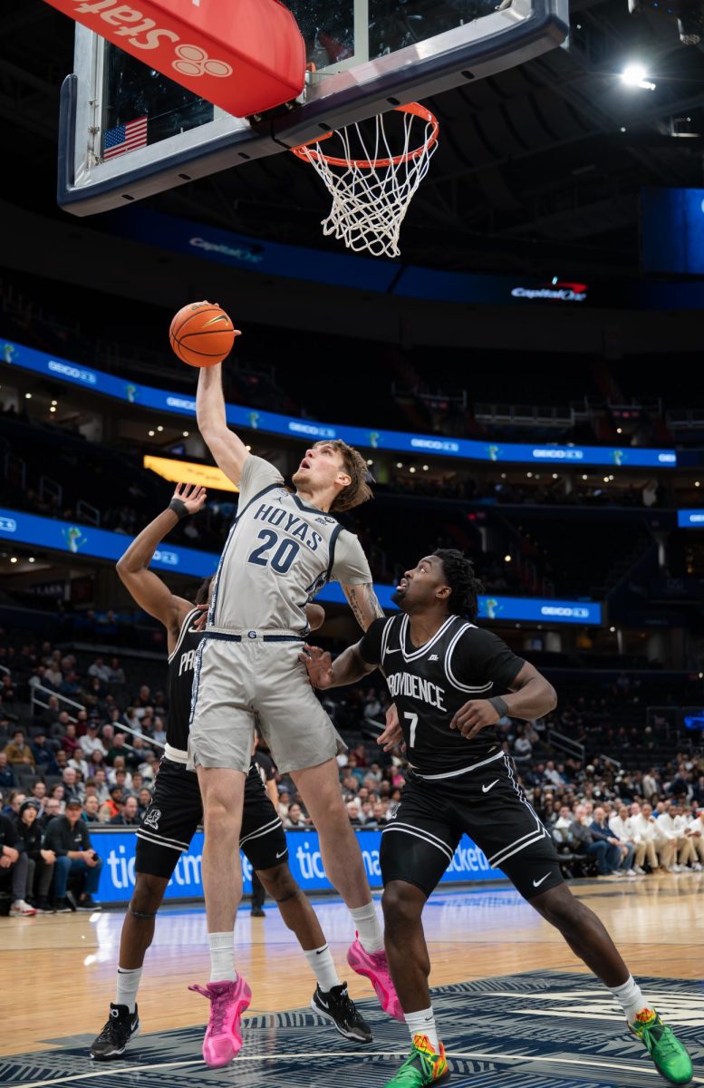 Sophomore forward Drew Fielder grabs a rebound over two Providence players. Fielder notched 17 points and 9 rebounds in the Hoyas' 93-72 win over the Friars, Head Coach Ed Cooley's former team. (Meghan Hall/The Hoya)