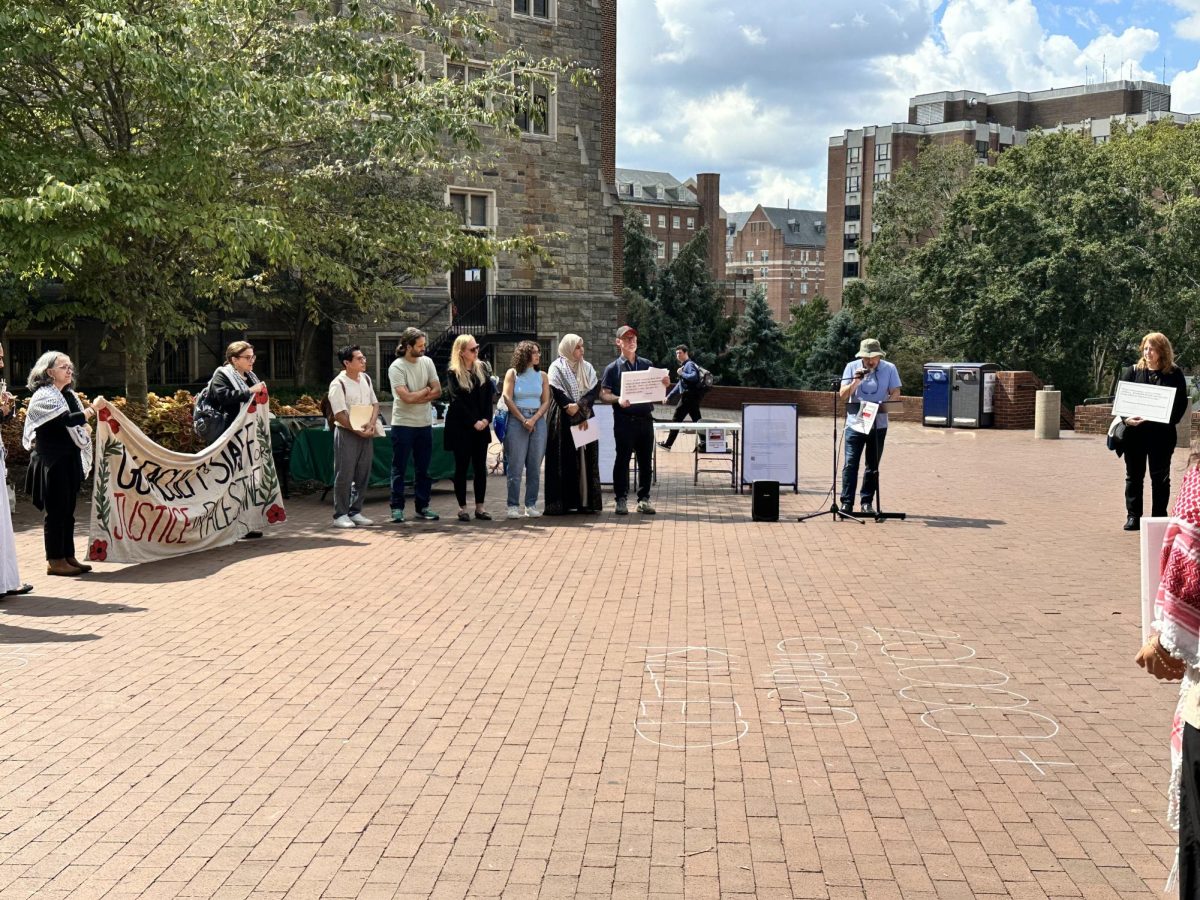 Ajani Stella/The Hoya | At a vigil for Gaza by a faculty group, faculty read out names of children killed. 