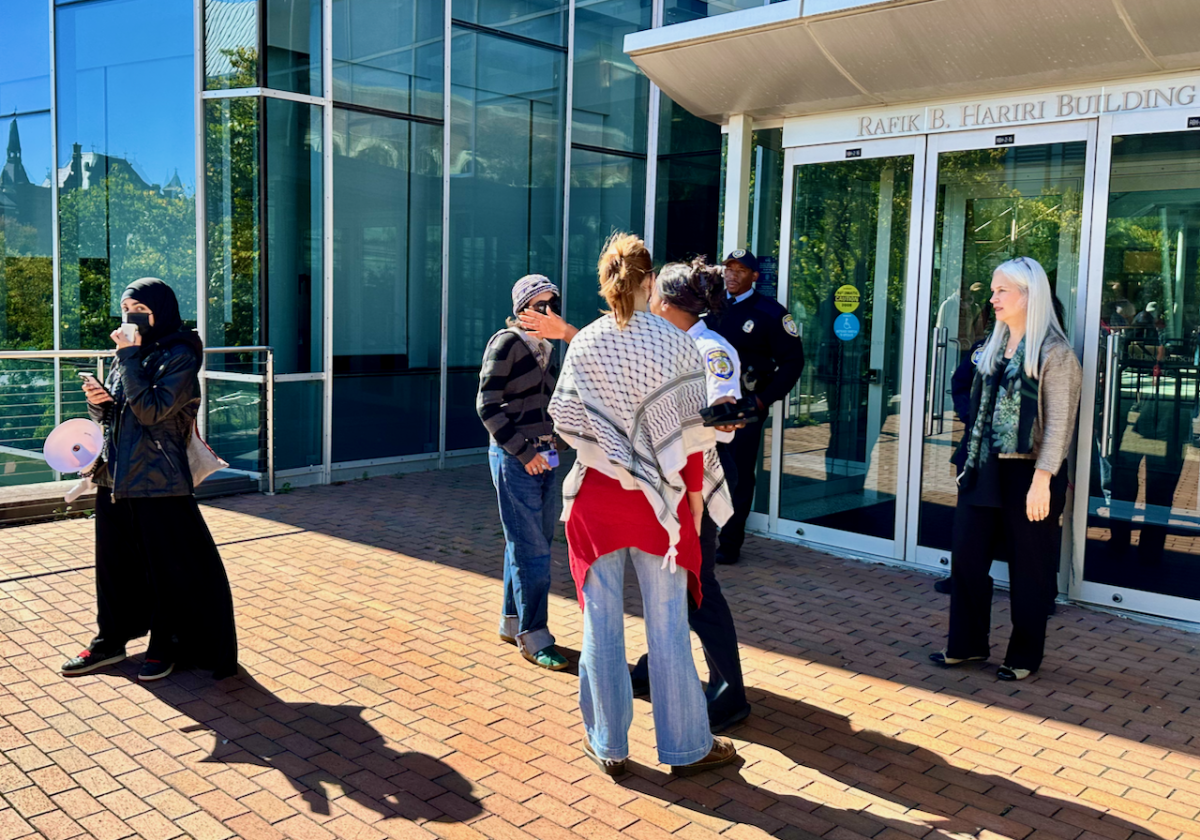 Georgetown University Police Department (GUPD) officers and a university administrator blocked the protesters from entering the Hariri Building, where the dialogue was held, and directed them to return to outside the first-floor entrance of Hariri.