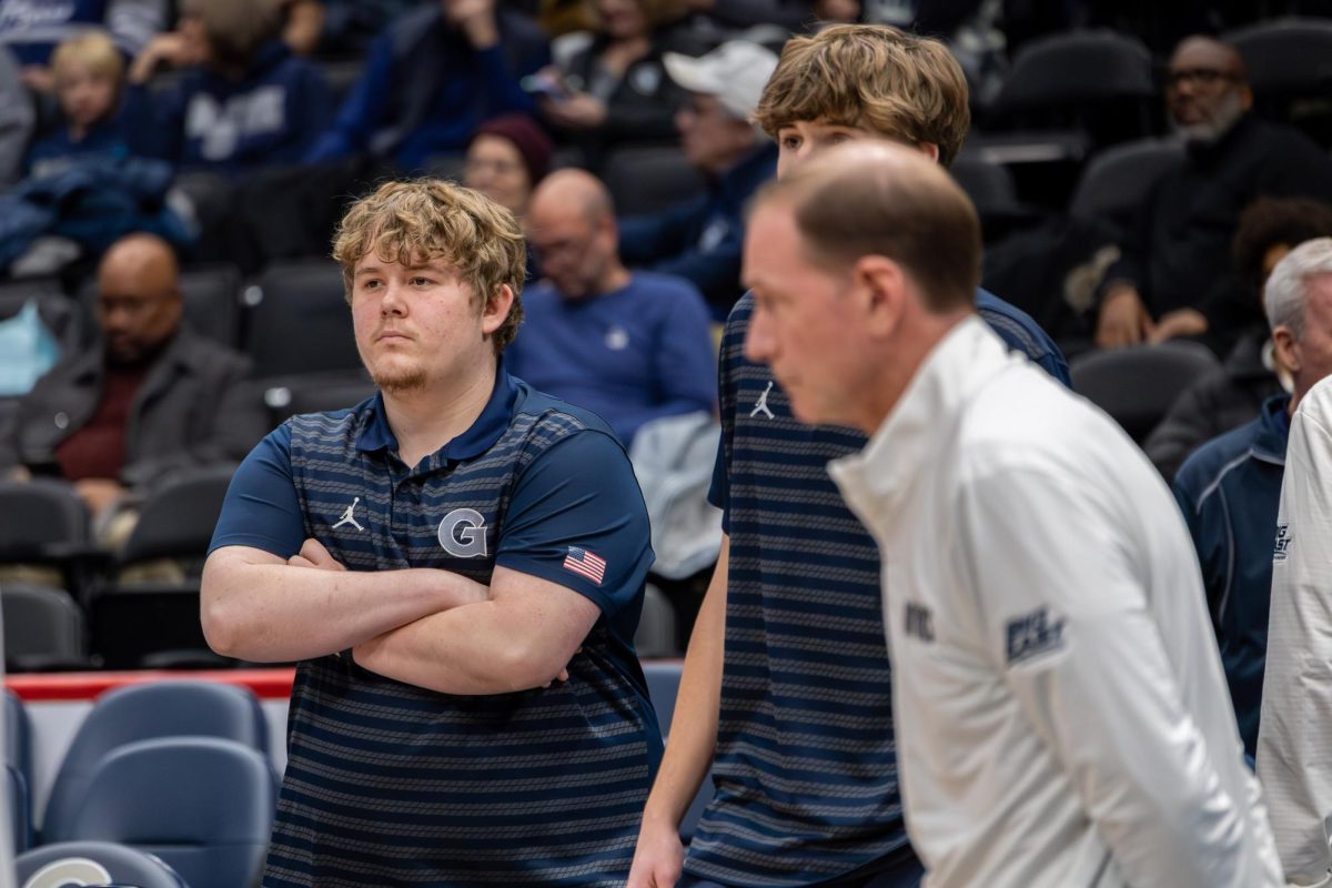Head manager Ben Cooper (left) is part of a squad that contributes 30 hours per week towards Georgetown men's basketball.